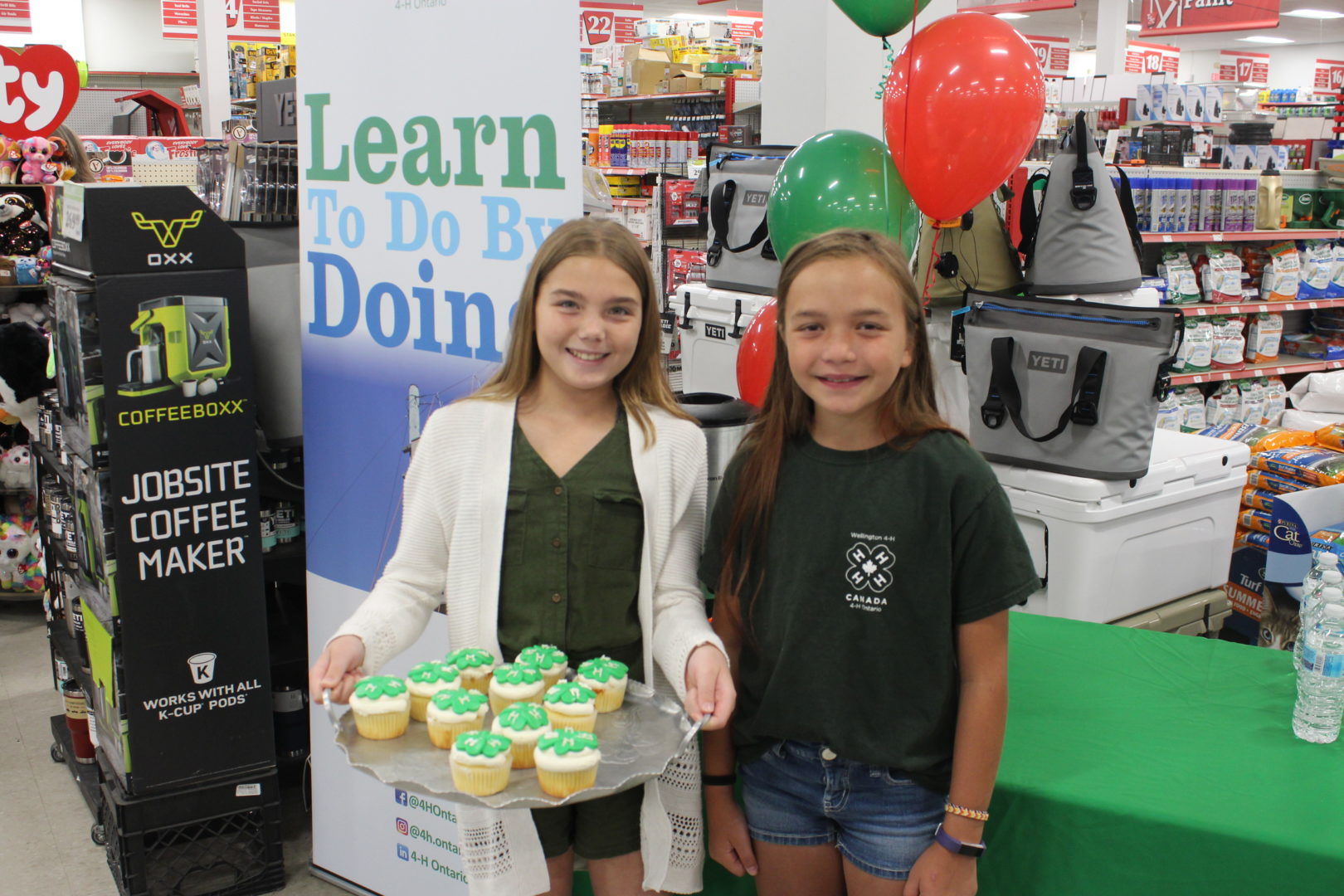 Two girls in a store with 4-H cupcakes