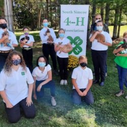 4-H Rabbit club members and judge on achievement day