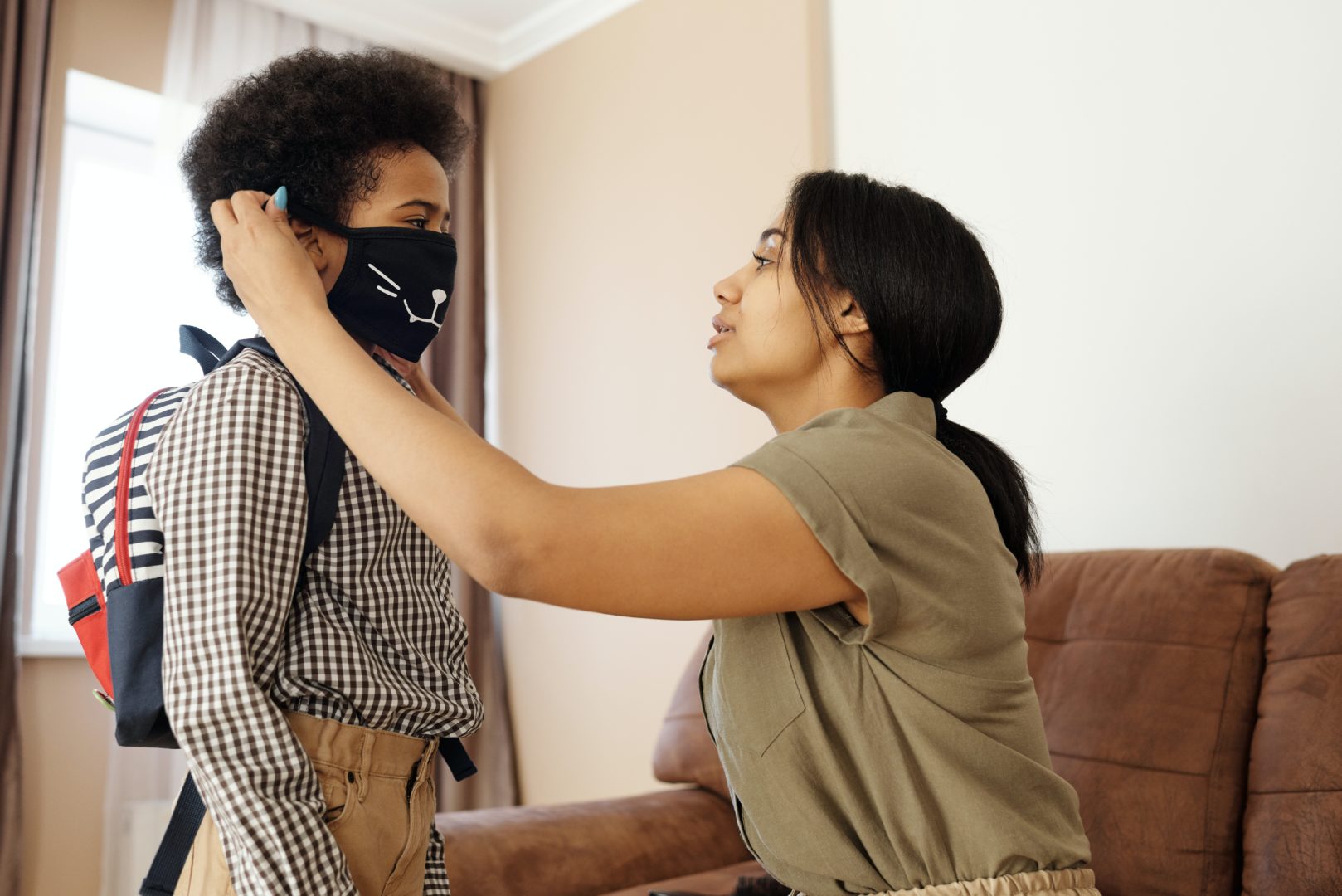 Kid with parent putting on mask