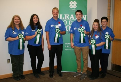 Haldimand 4-H team in blue 4-H t-shirts holding 5th place ribbons from the Go for the Gold competition at the Royal Agricultural Winter Fair in 2019.